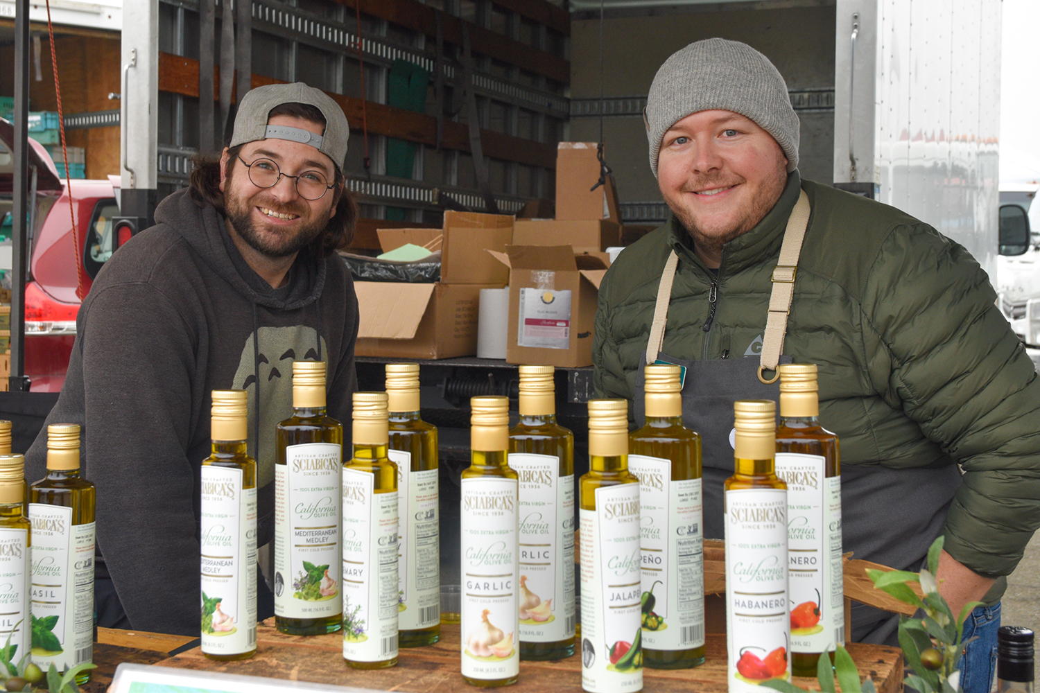 Two people at Sciabica Olive Oil's FPFM stand