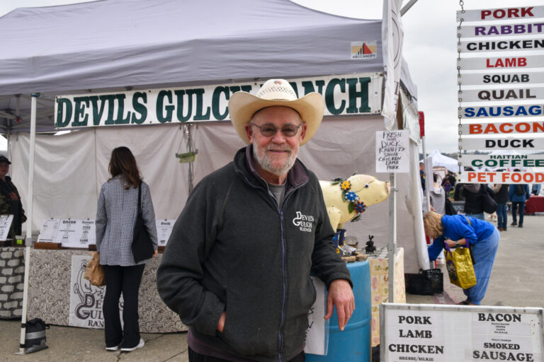 Mark Pasternak stands in front of Devil's Gulch Ranch at the Ferry Plaza Farmers Market in San Francisco.