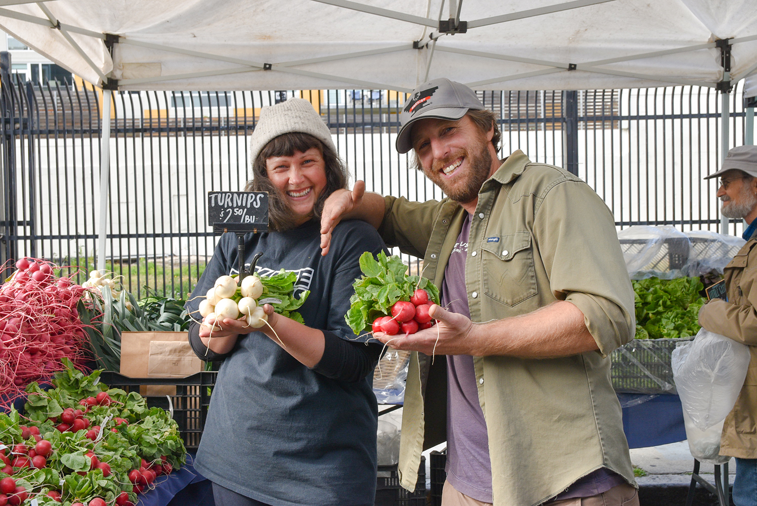 Two people at Blue House Farm's stand at Mission Community Market