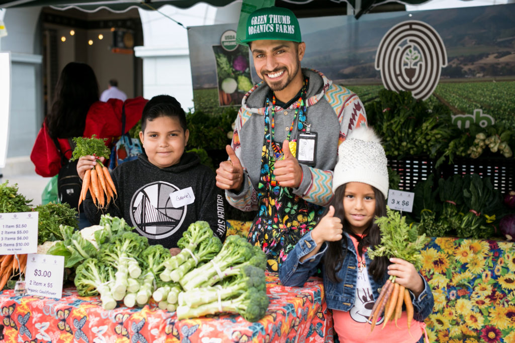 Farmer with children at the Ferry Plaza Farmers Market