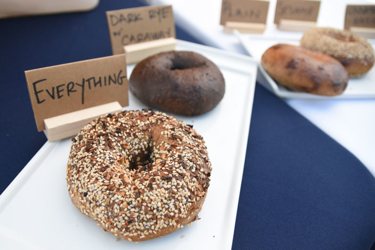 Two bagels on a white dish at Midnite Bagel's stand at the Ferry Plaza Farmers Market in San Francisco.
