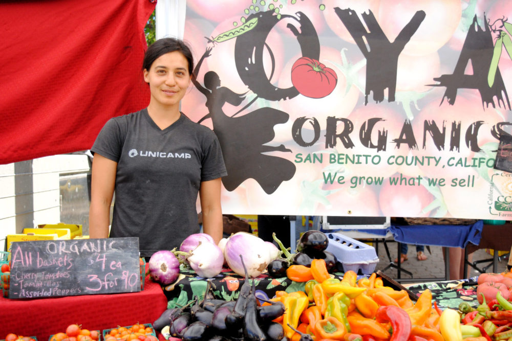 Marsha Habib poses at Oya Organics' stand at the Ferry Plaza Farmers Market