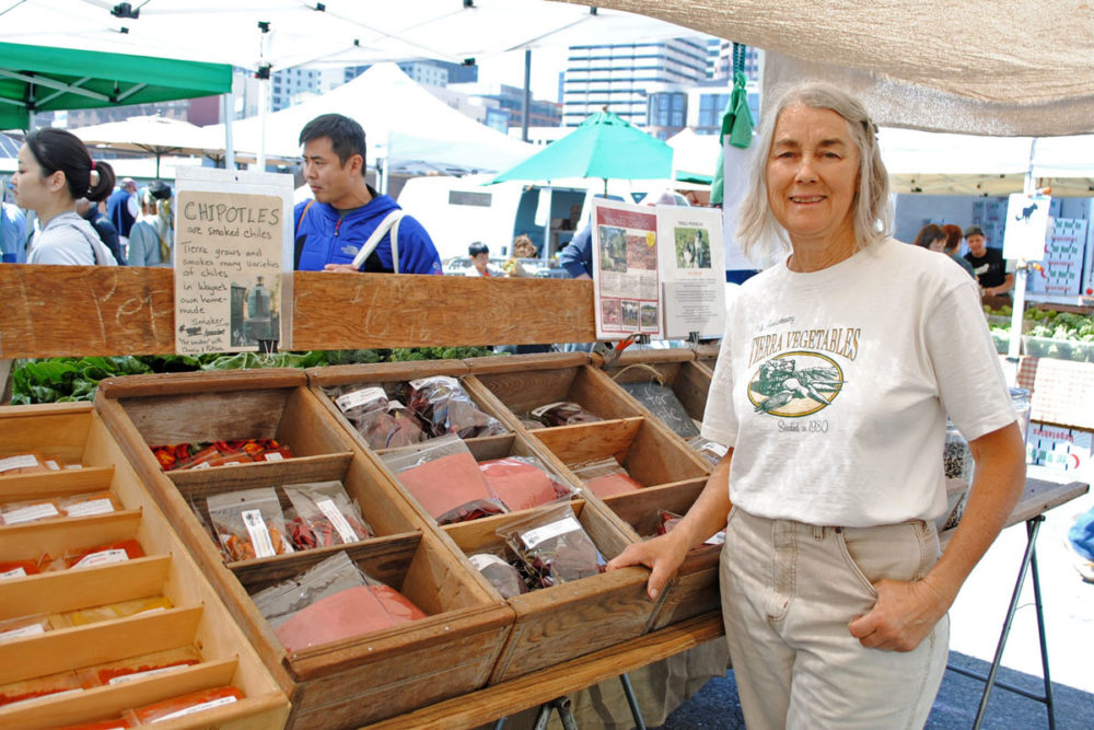 Lee James poses at Tierra Vegetables stand at the Ferry Plaza Farmers Market in San Francisco.