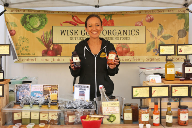 Mary Risavi poses at Wise Goat Organics' stand at the Ferry Plaza Farmers Market