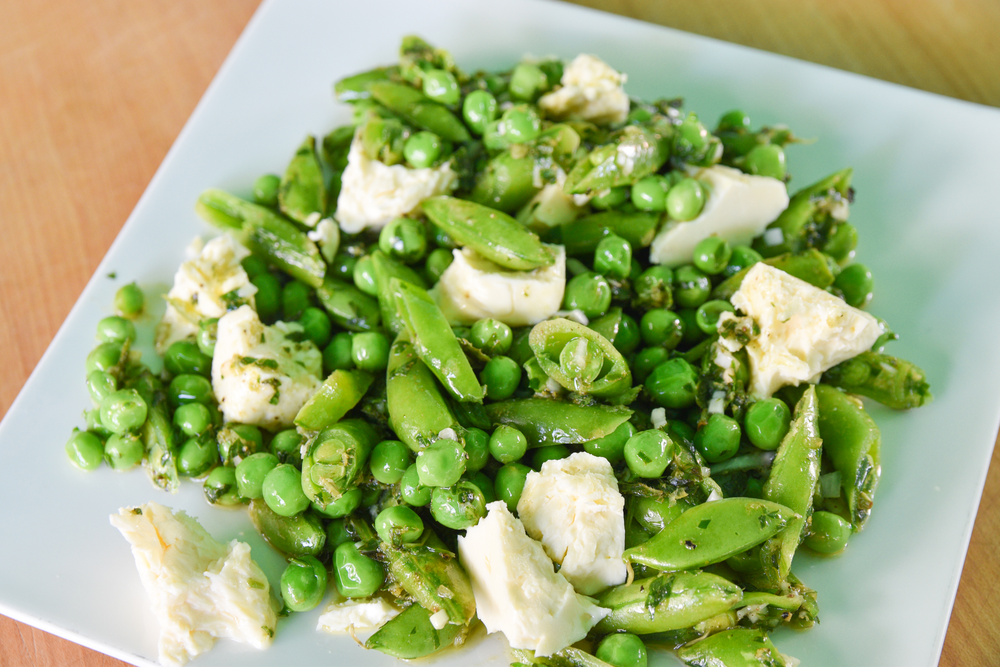 https://foodwise.org/wp-content/uploads/2022/06/Peas_with_feta_and_zhoug_baraghani.jpg