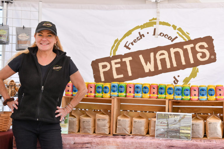 Christine poses at Pet Wants San Francisco's stand at the Mission Community Market