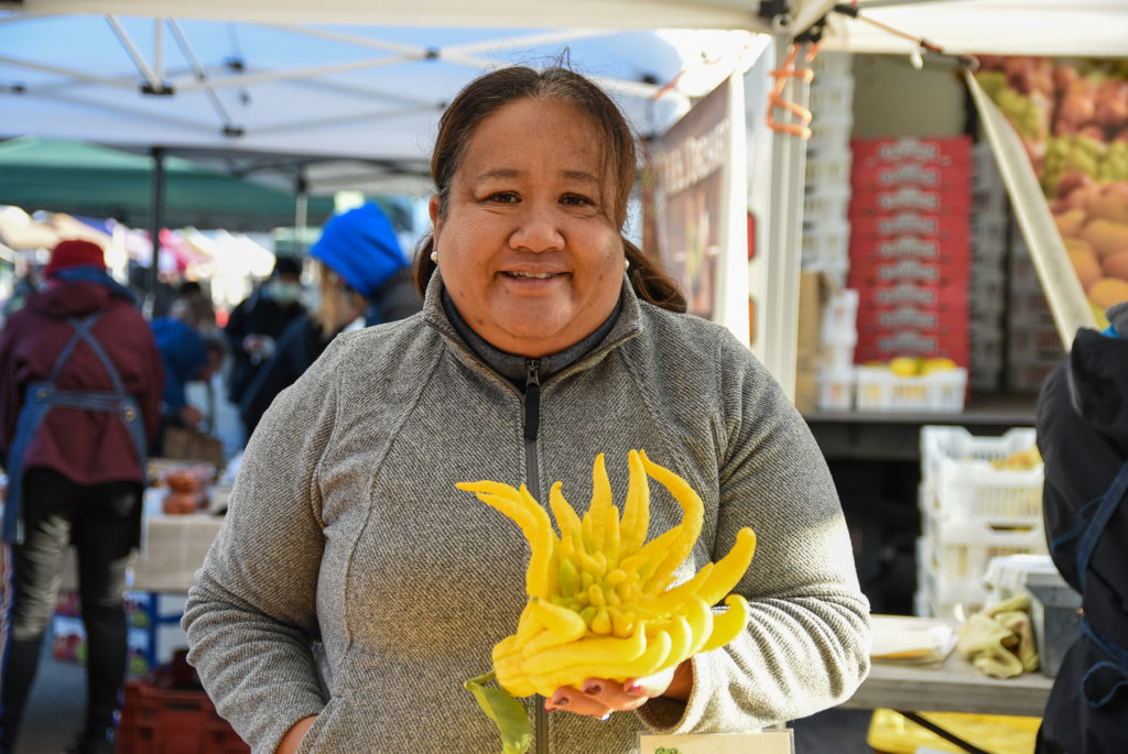 Aomboon Deasy of K&J Orchards with Buddha's hand citron at Ferry Plaza Farmers Market