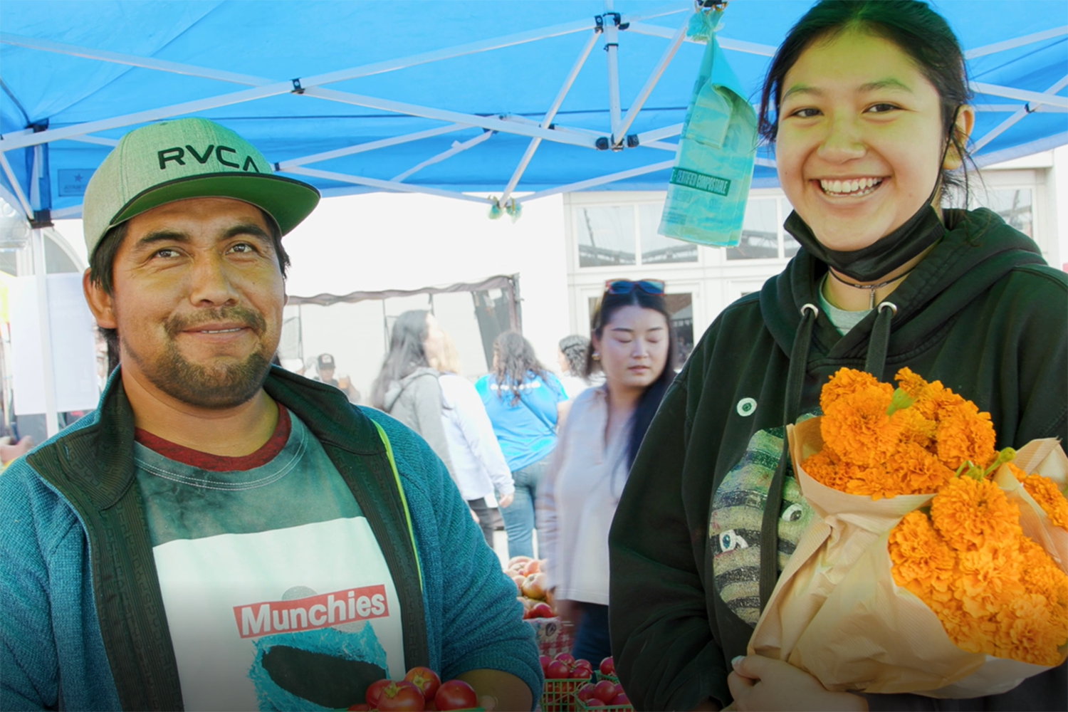Farmer Modesto Sanchez and Foodwise Teens participant Luzaneth Garcia at the Oya Organics stand at the Ferry Plaza Farmers Market