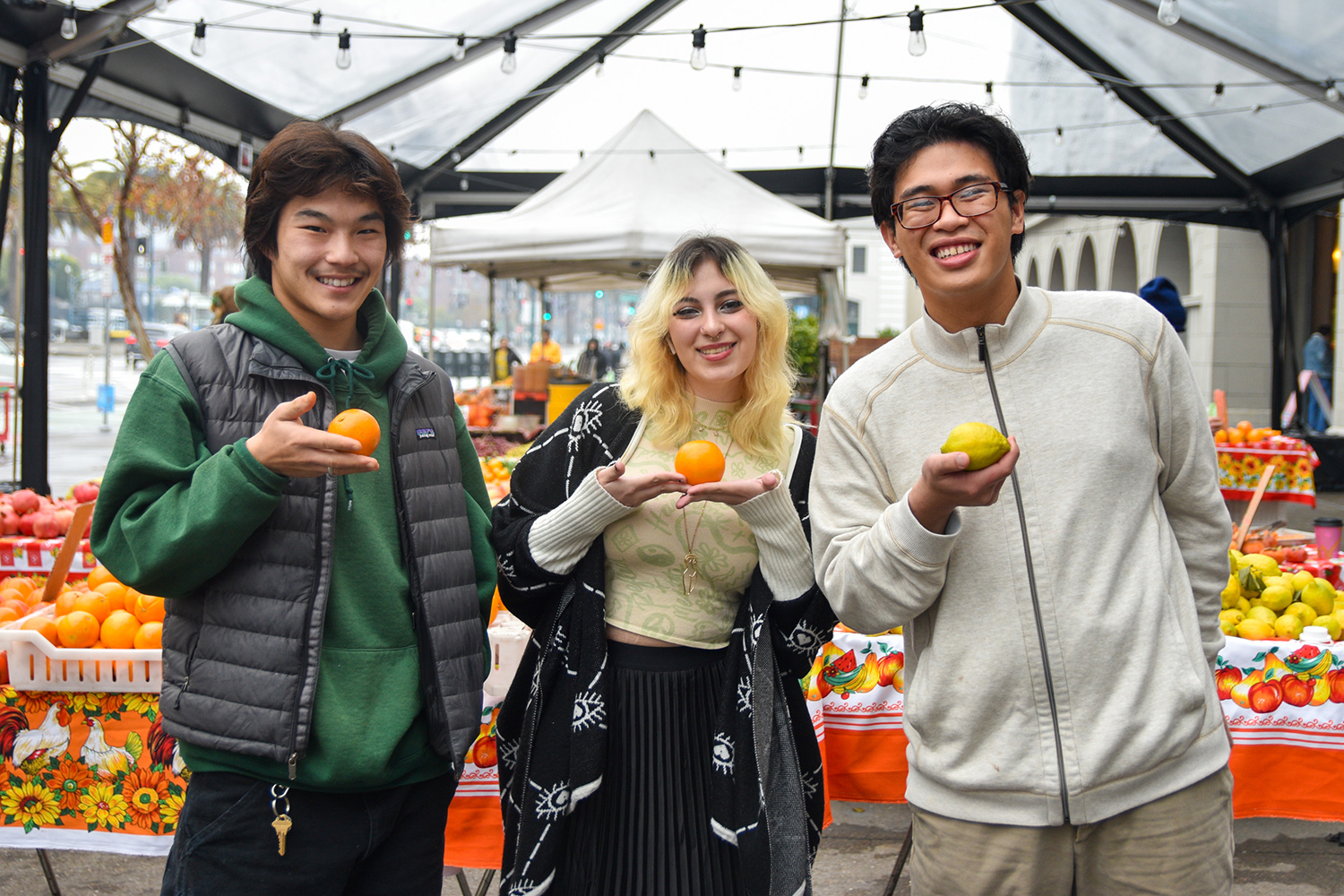 FWT interns in the farmers market, from left to right: Yungmin, Sofia, and maybe: Rayyane