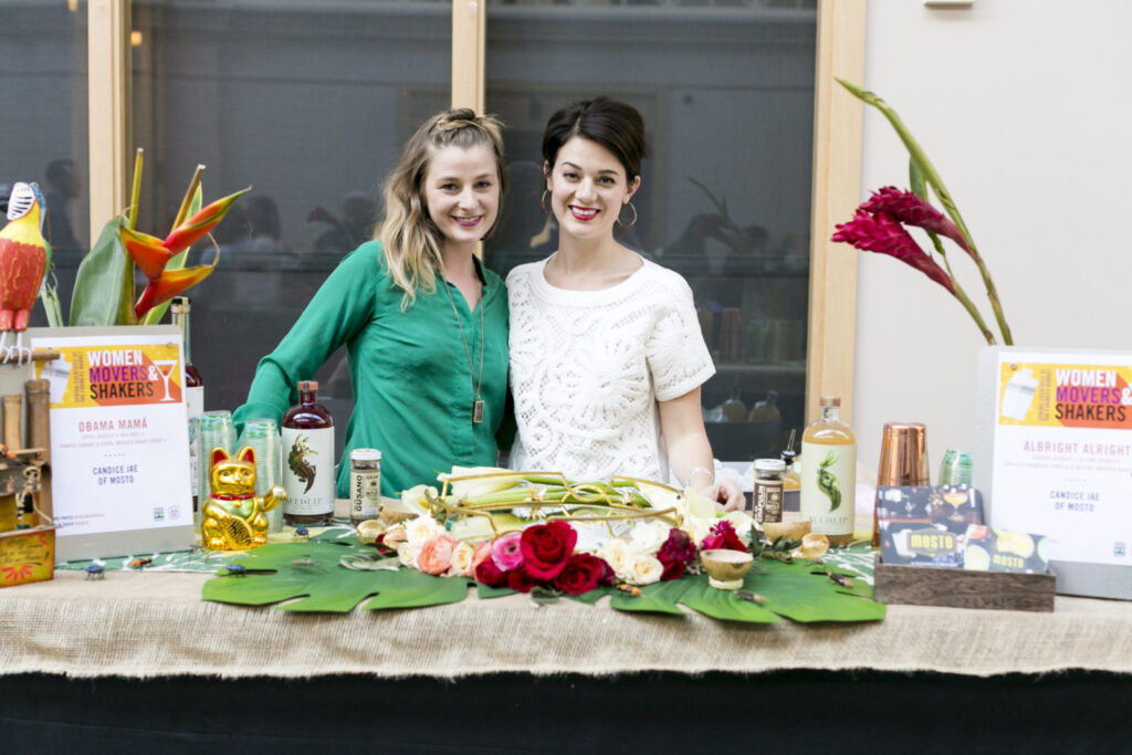 Two people standing behind a festively decorated table at a Foodwise event
