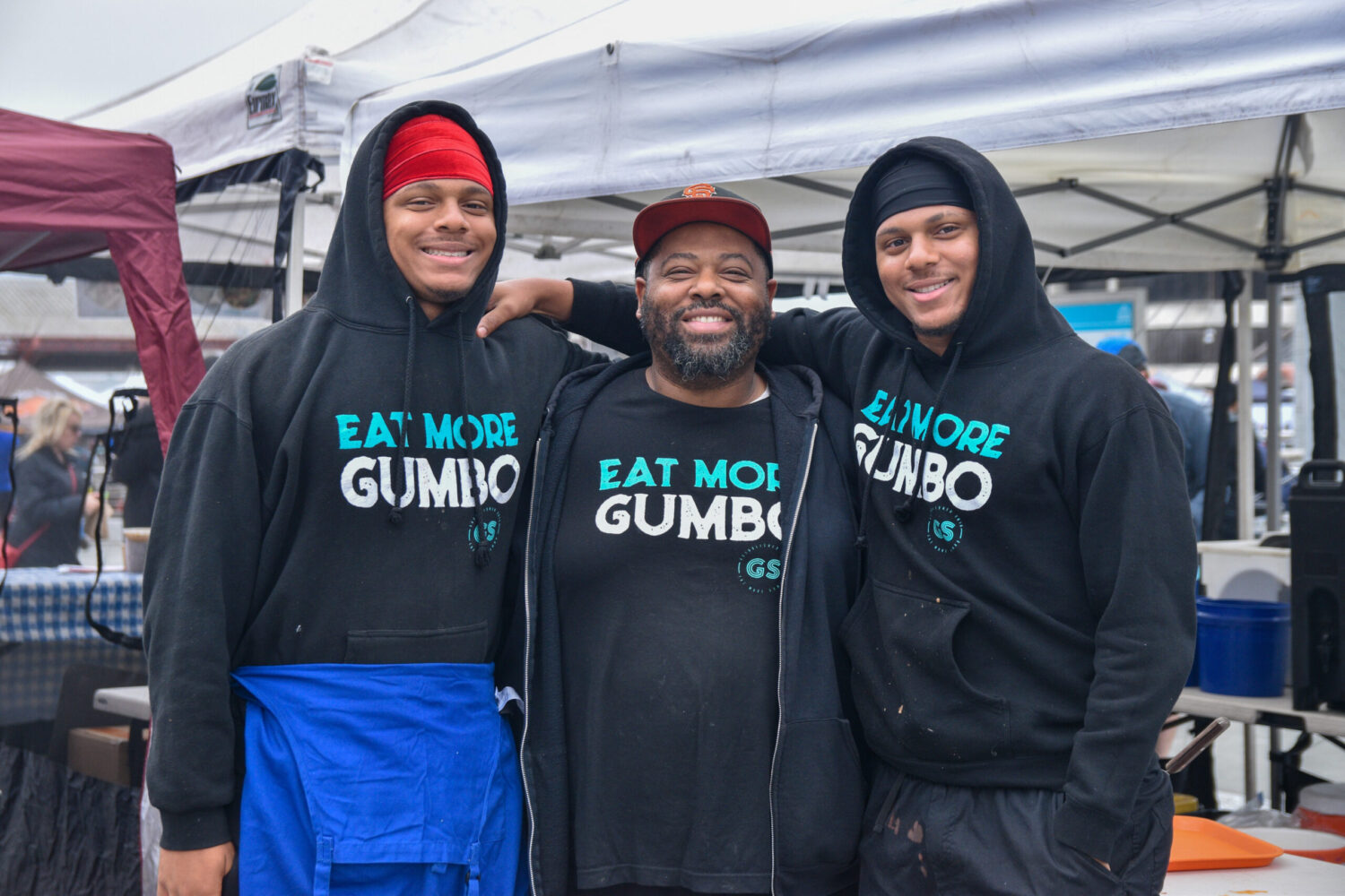 Gumbo Social owner Dontaye Ball, and his sons, at the Ferry Plaza Farmers Market.