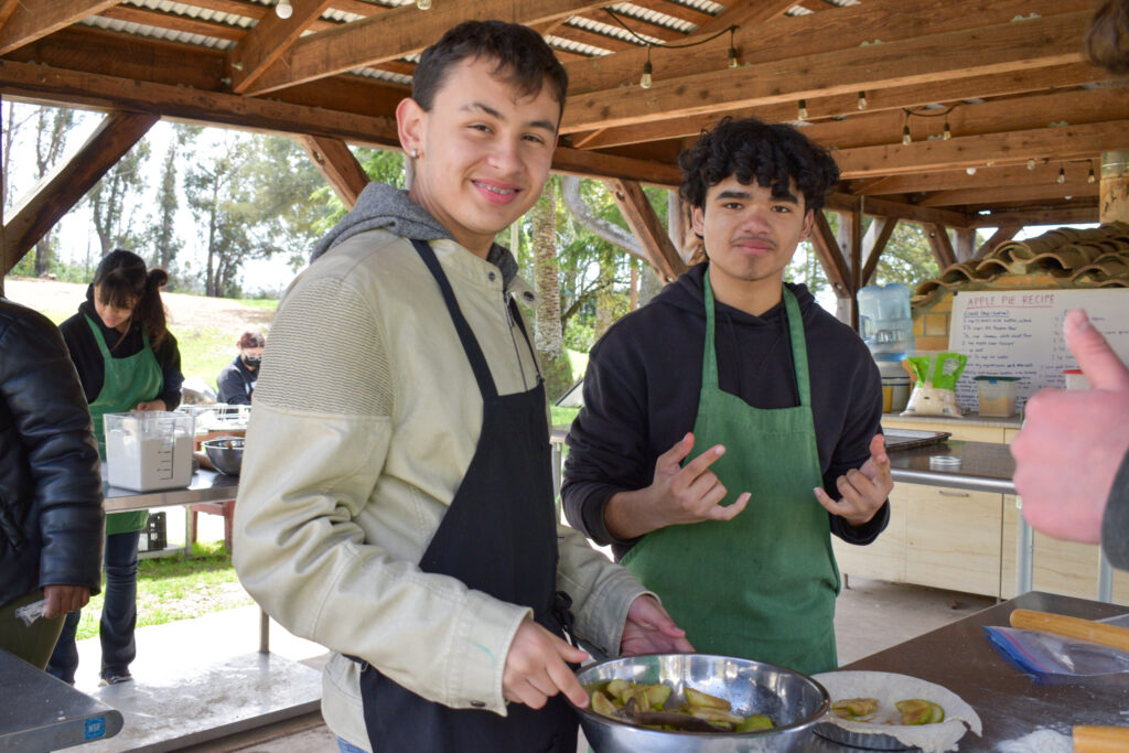 Foodwise Teens posing for a photo with their handmade pie on a field trip to a local farm.