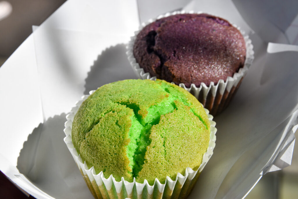 Two of SF Chickenbox's mochi muffins, one pandan and one ube flavored