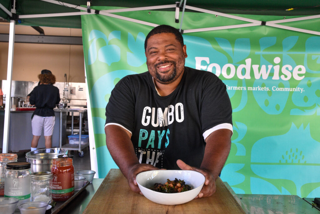 Dontaye Ball holds a bowl of California Greens gumbo at the Foodwise Classroom at the Ferry Plaza Farmers Market in San Francisco.