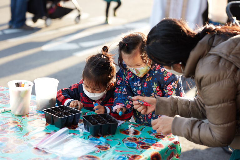 Photo of seed planting family activity at the Mission Community Market
