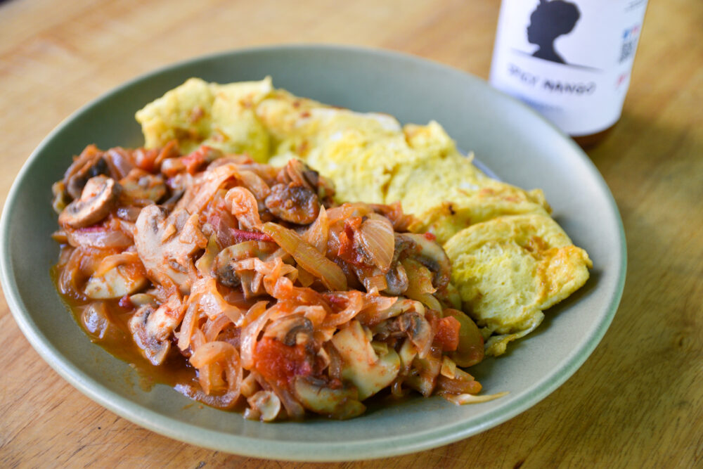 Evolution Hot Sauce Breakfast, made with eggs, cabbage, and mushrooms.